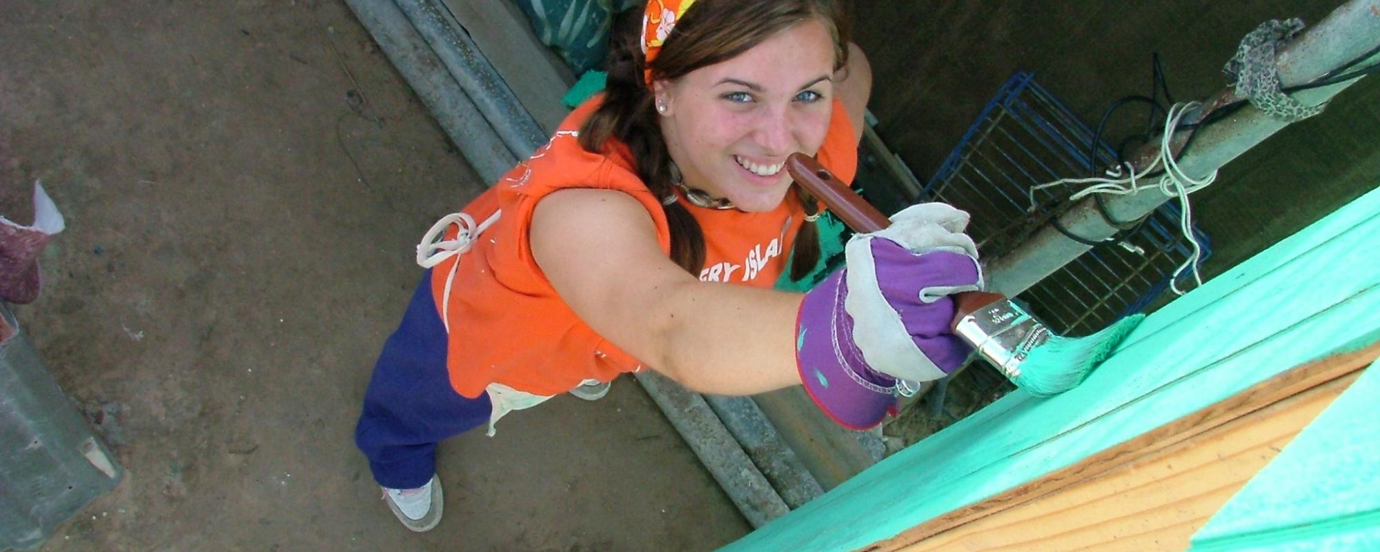 volunteer smiling and painting