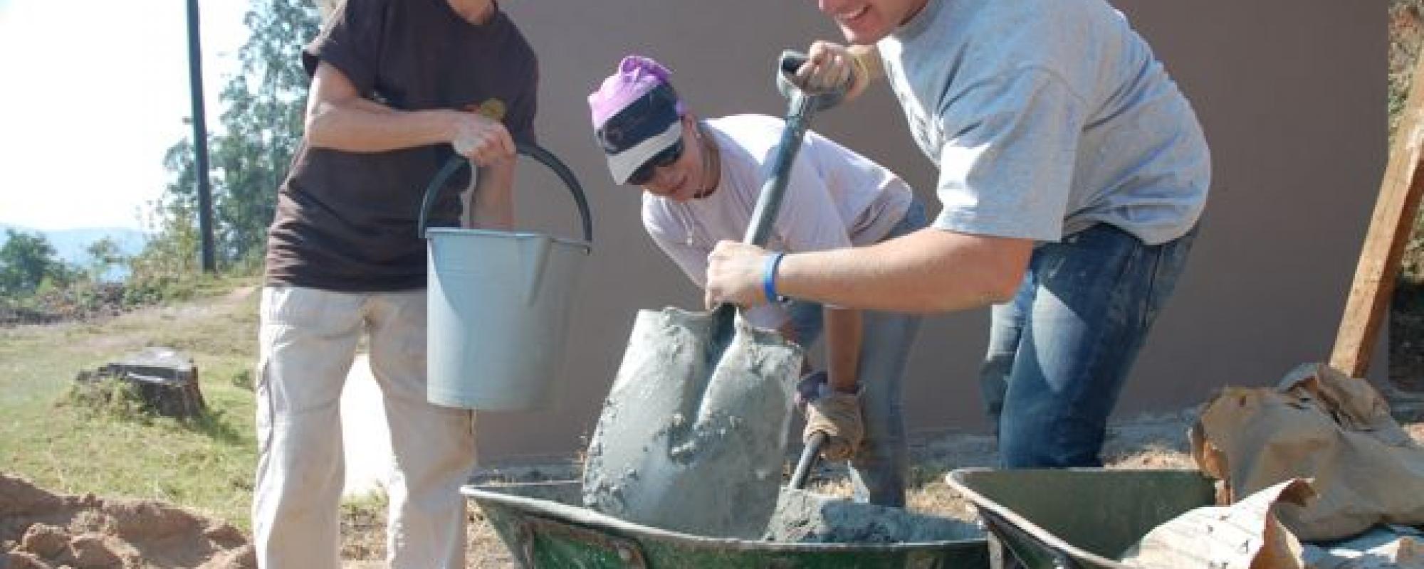Volunteers mixing concrete